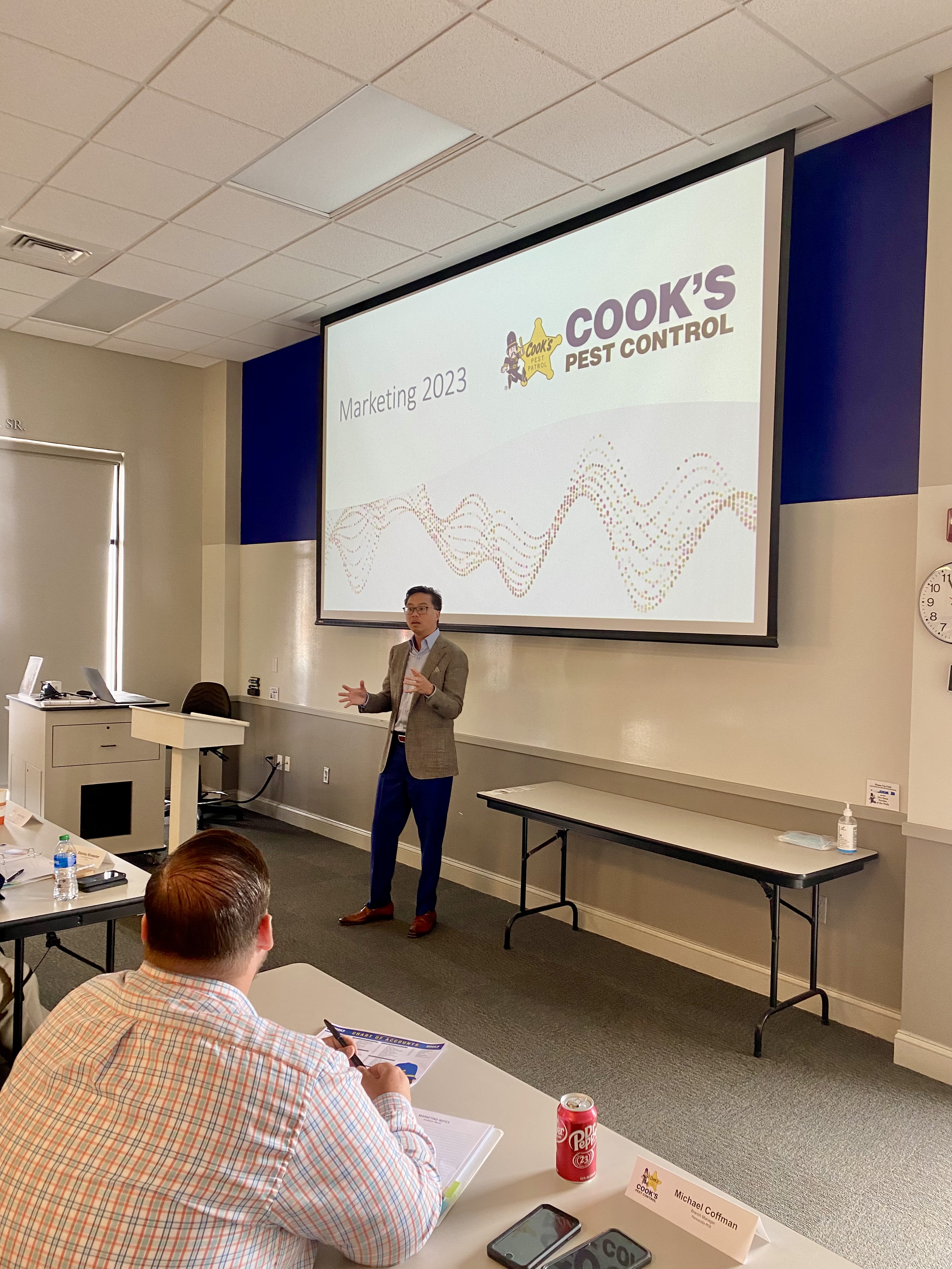 Jonathan Moral presenting the Cook's Pest Control 2023 marketing plan to managers