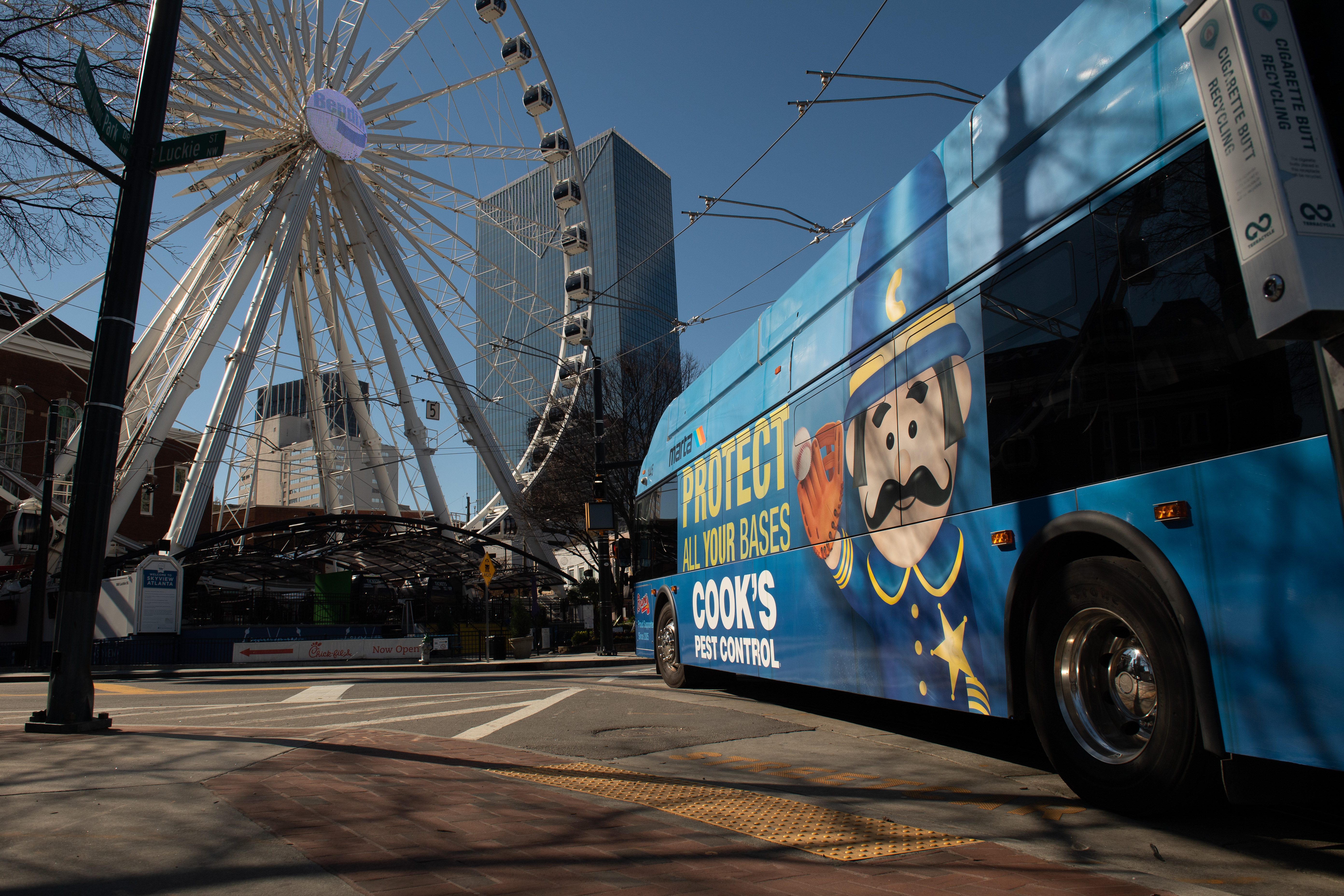 A MARTA bus wrapped in Cook's Pest Control advertising in downtown Atlanta